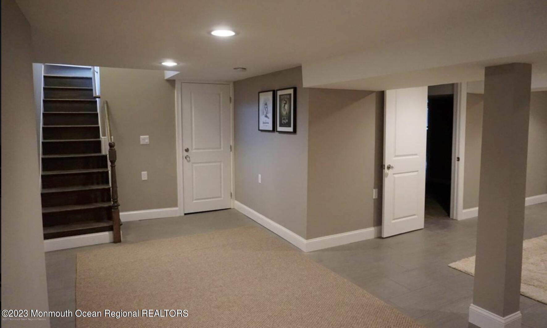 469 Ocean Avenue North, Unit WINTER Long Branch, NJ 07740 - Photo 32 of 47 a view of an empty room with a cabinet and stairs