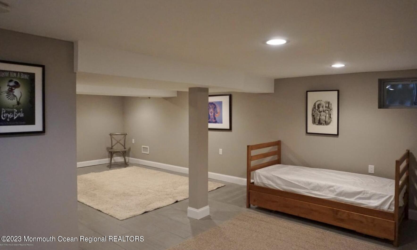469 Ocean Avenue North, Unit WINTER Long Branch, NJ 07740 - Photo 34 of 47 a bedroom with a bed and a lamp on dresser