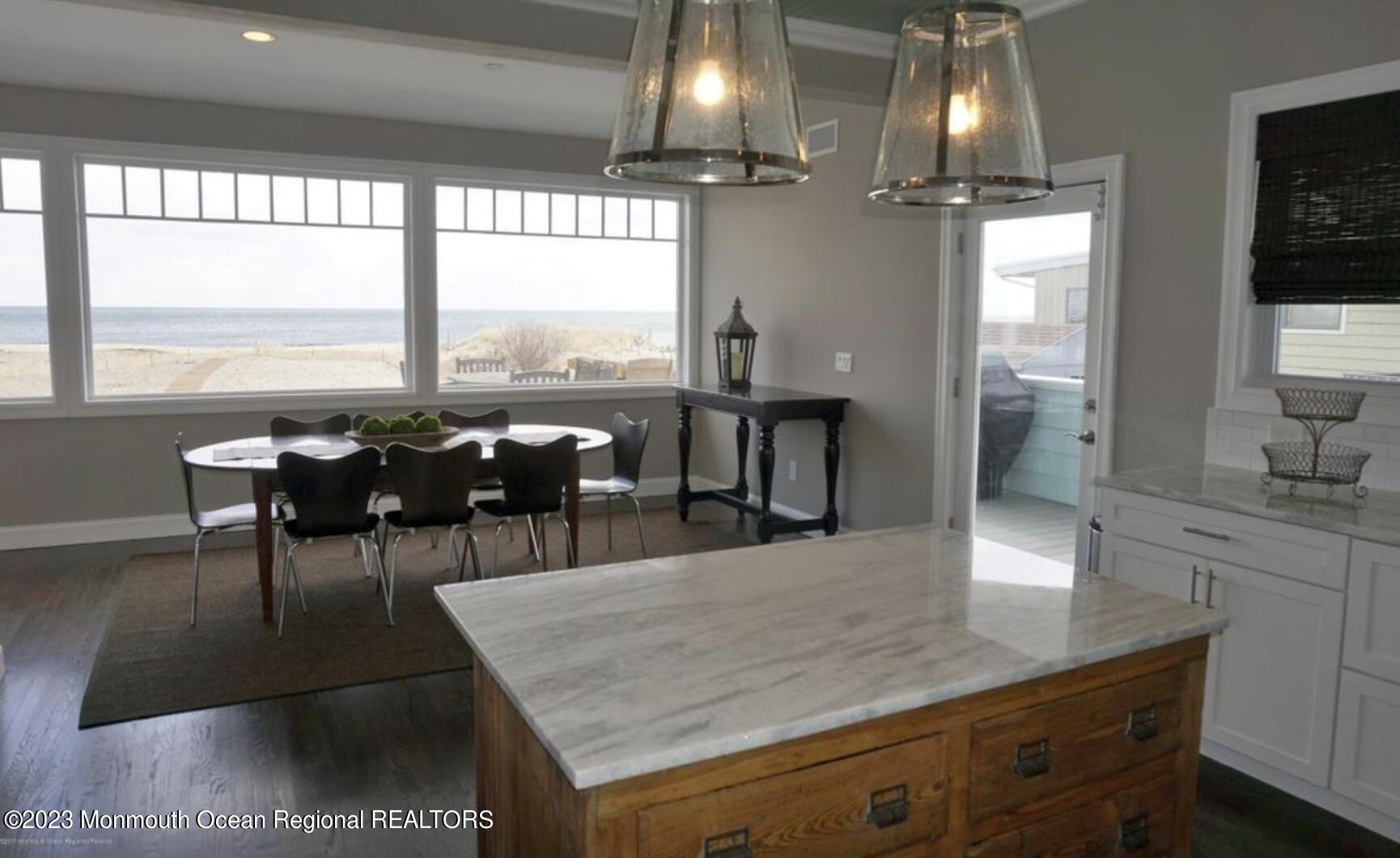 469 Ocean Avenue North, Unit WINTER Long Branch, NJ 07740 - Photo 8 of 47 a view of a dining room with furniture and chandelier or kitchen