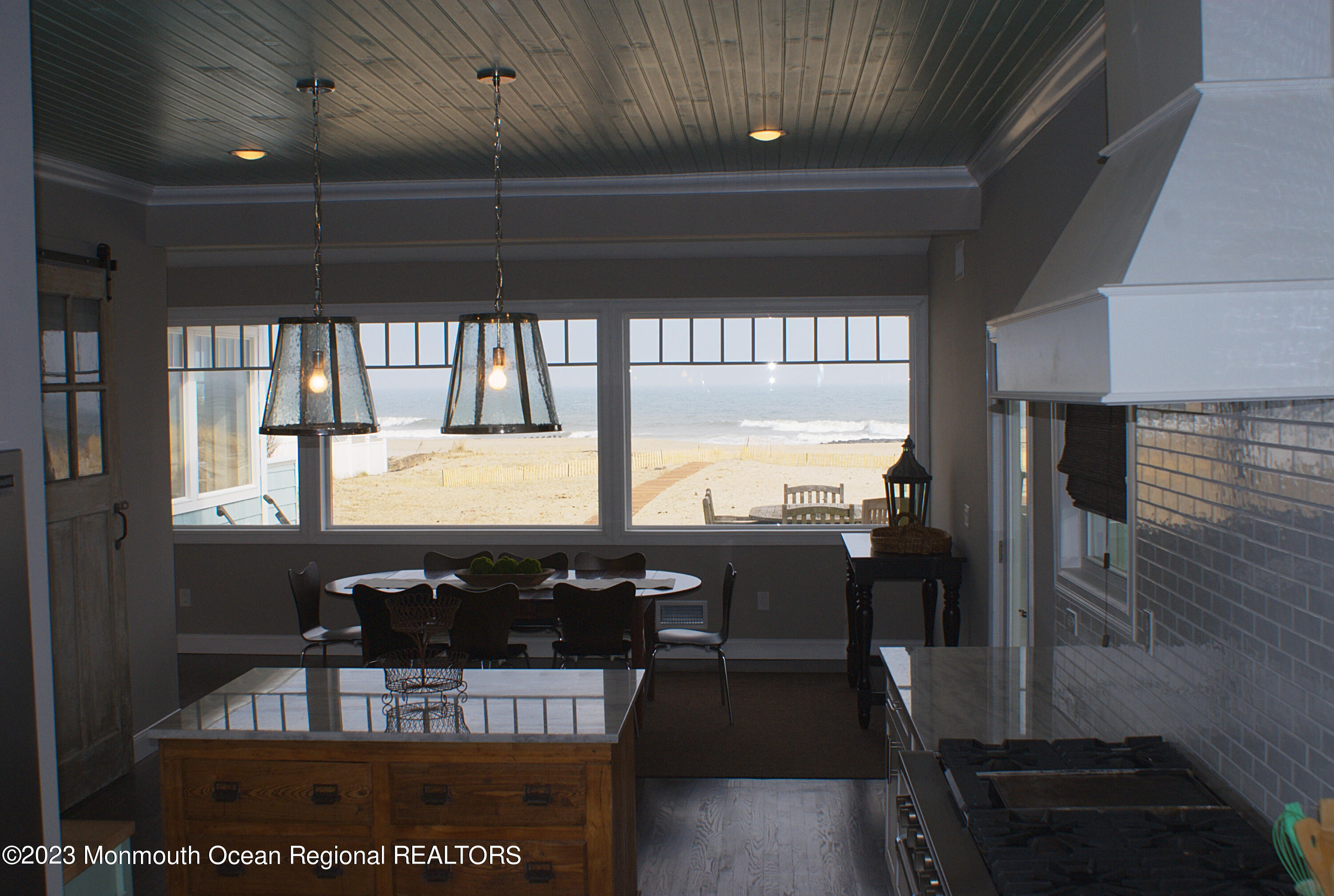 469 Ocean Avenue North, Unit WINTER Long Branch, NJ 07740 - Photo 9 of 47 a view of a dining room with furniture wooden floor and chandelier