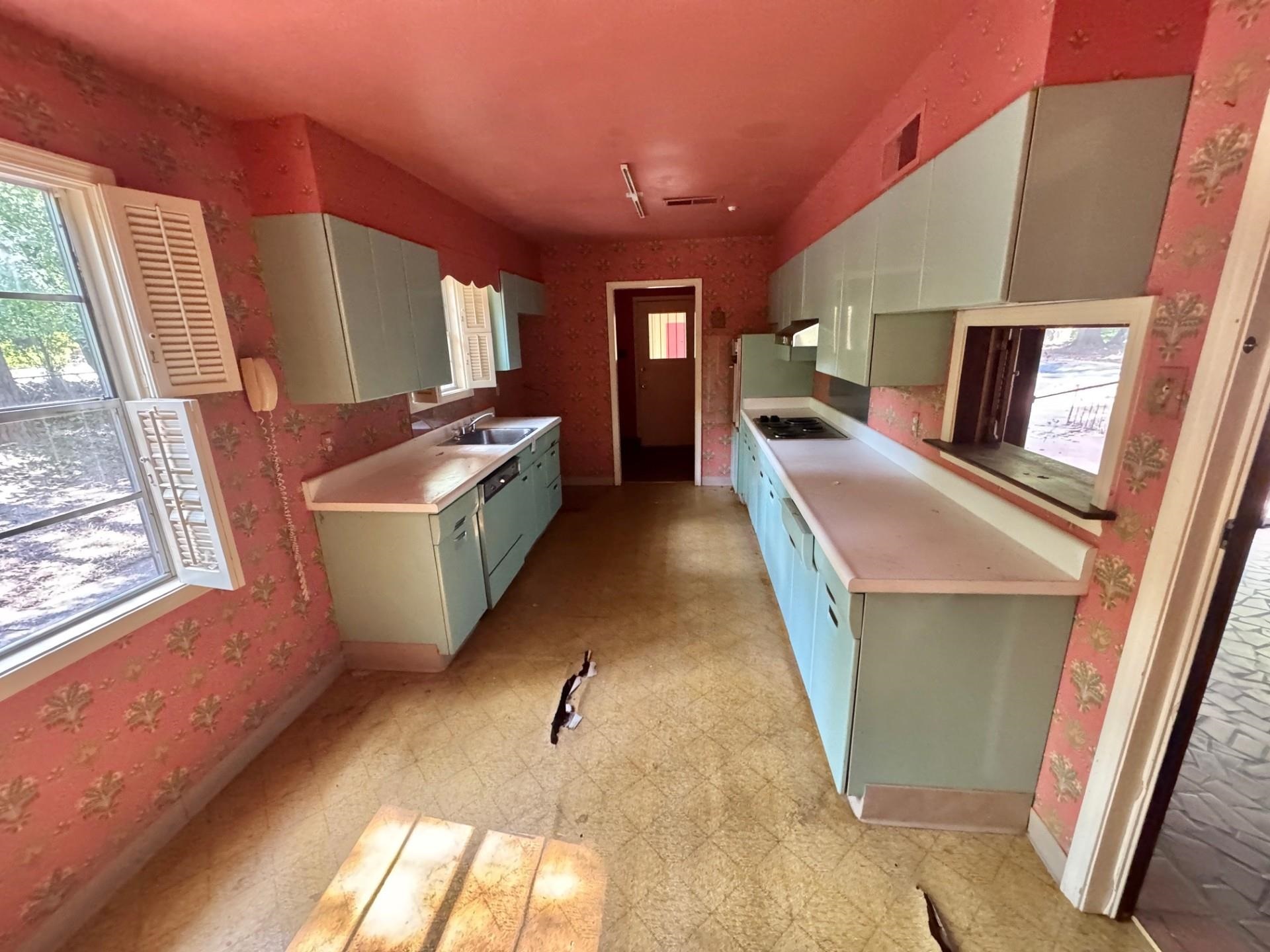 5429 Normandy Road Memphis, TN 38120 - Photo 17 of 25 Kitchen featuring light flooring, a sink, light countertops, and baseboards