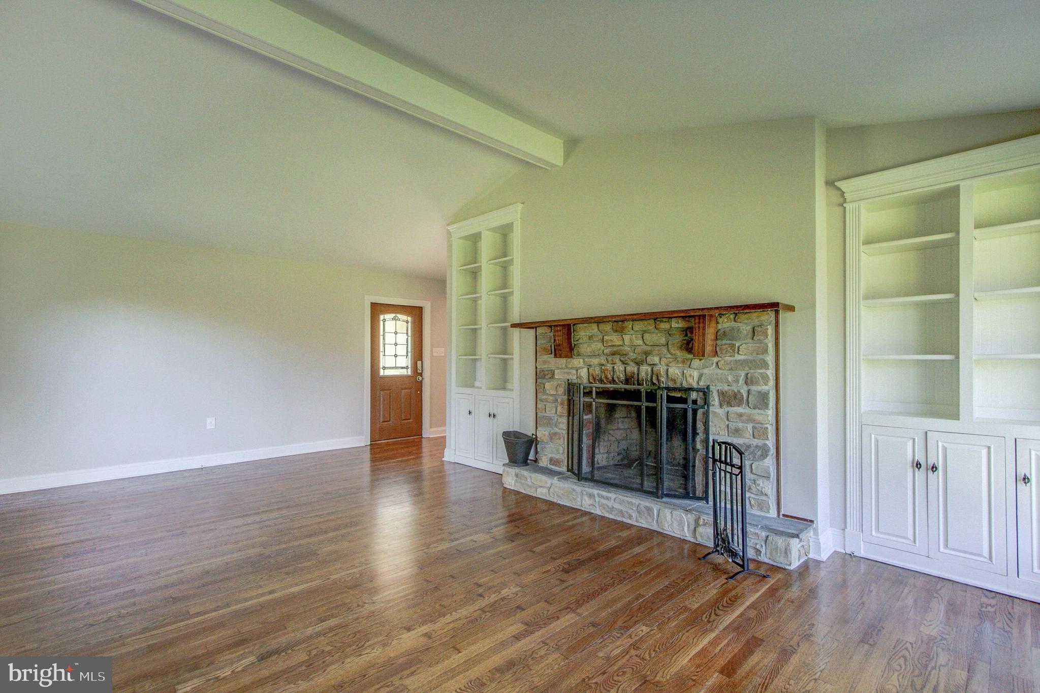 Family Room with Vaulted ceilings and wood floors
