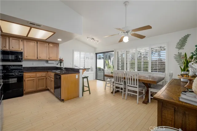 a kitchen with a table chairs refrigerator and cabinets