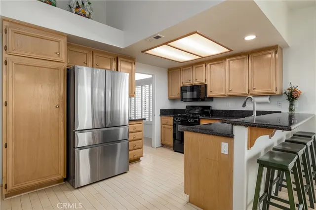 a kitchen with a refrigerator a stove top oven a sink and dishwasher