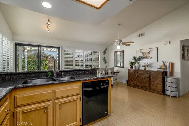 a kitchen with sink refrigerator and large window