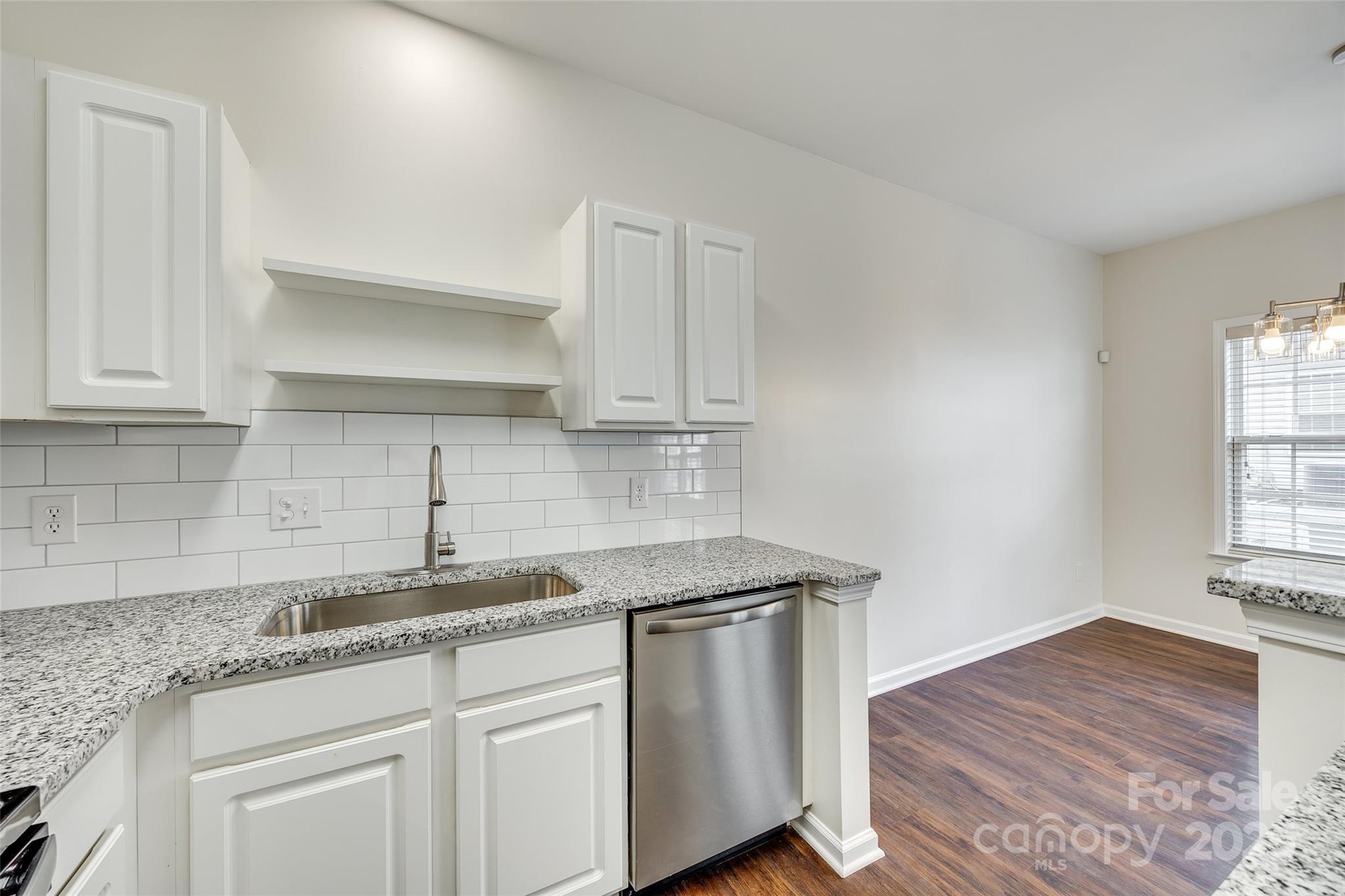 2035 Lennox Square Road Charlotte, NC 28210 - Photo 11 of 29 a kitchen with stainless steel appliances granite countertop a sink a stove cabinets and wooden floor