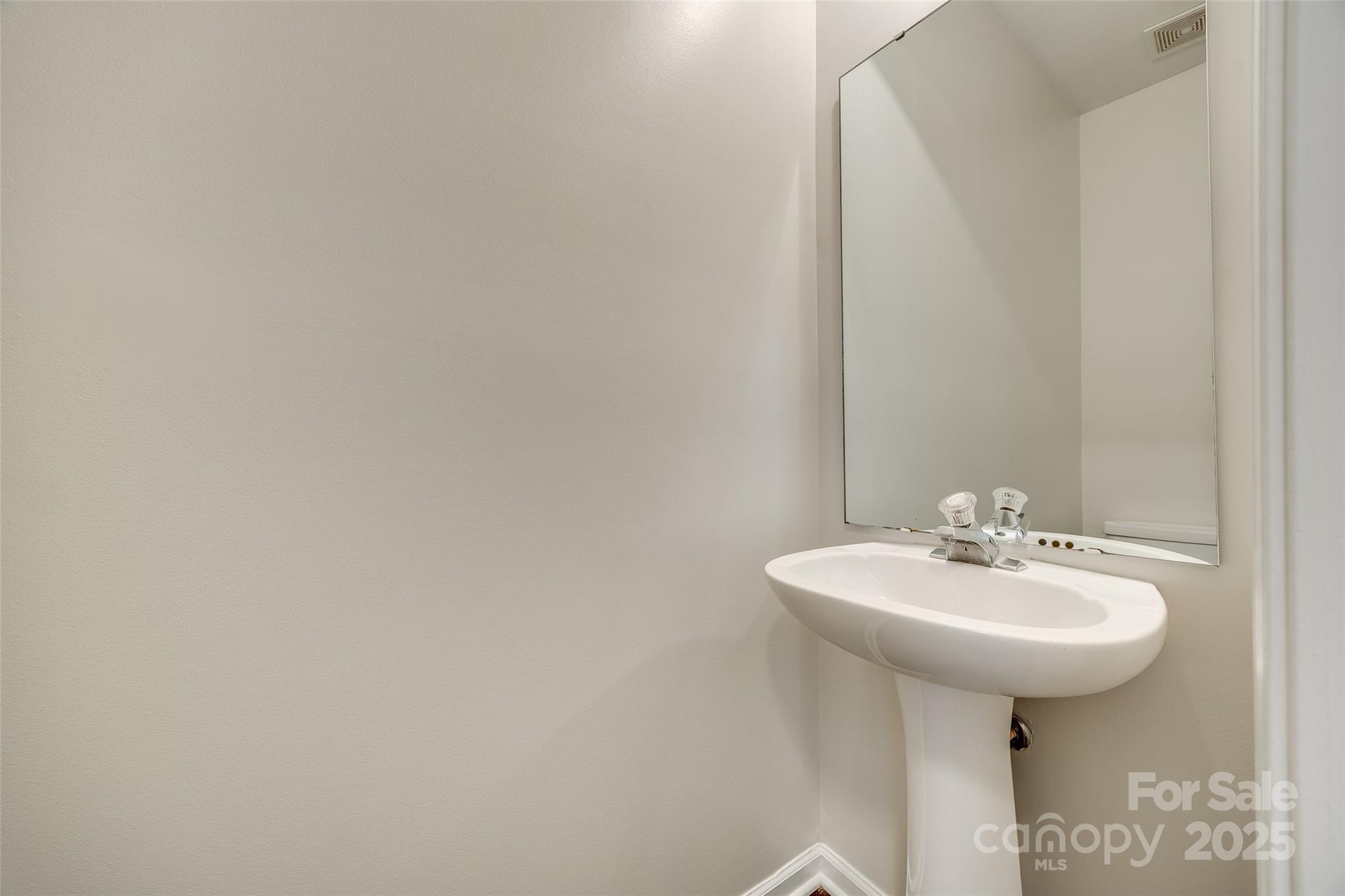 2035 Lennox Square Road Charlotte, NC 28210 - Photo 13 of 29 a bathroom with a sink and a mirror
