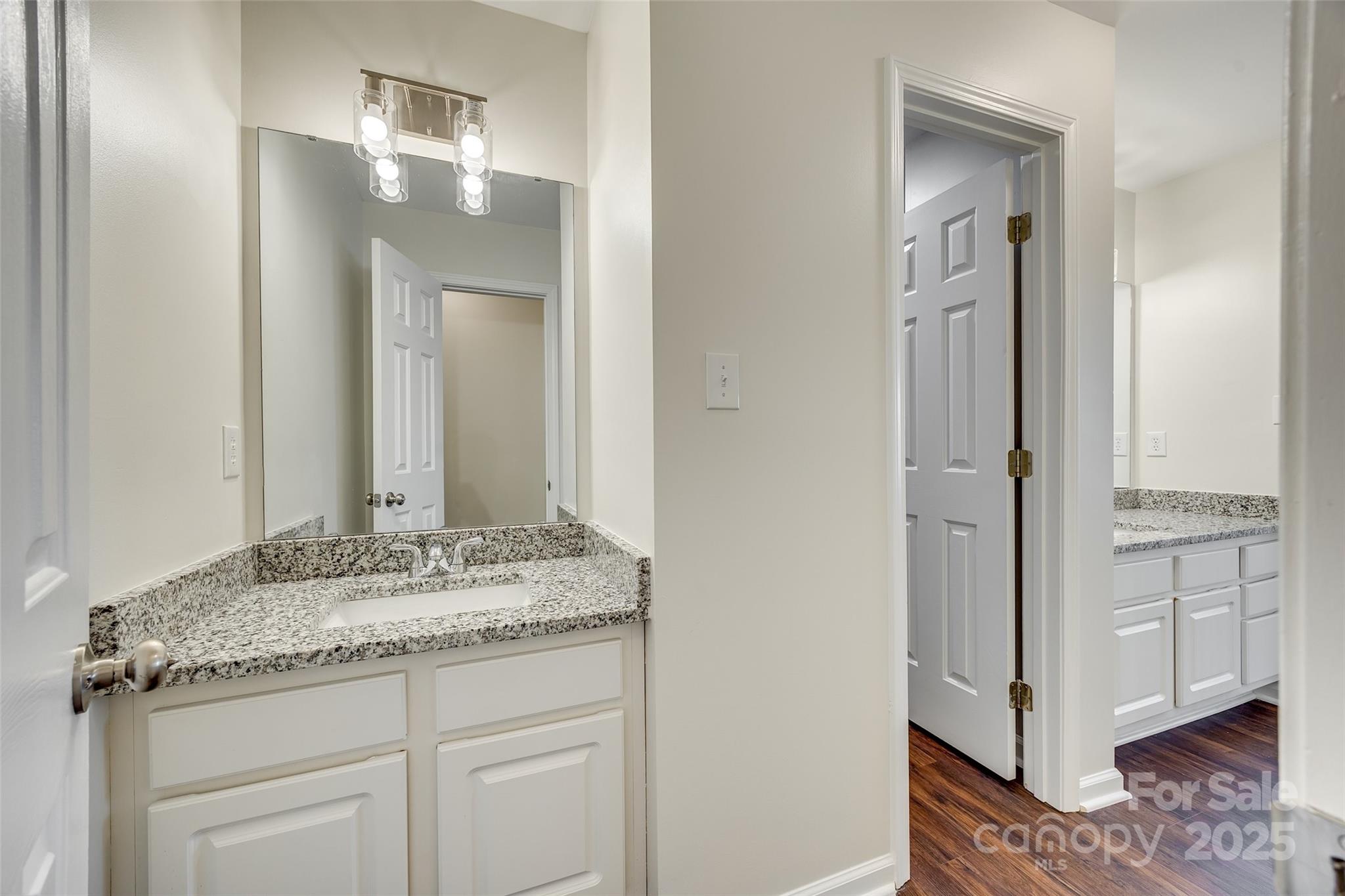 2035 Lennox Square Road Charlotte, NC 28210 - Photo 19 of 29 a bathroom with a granite countertop sink and a mirror