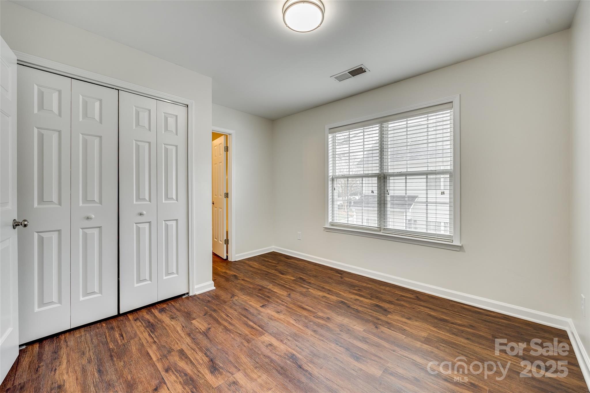 2035 Lennox Square Road Charlotte, NC 28210 - Photo 22 of 29 an empty room with wooden floor and windows