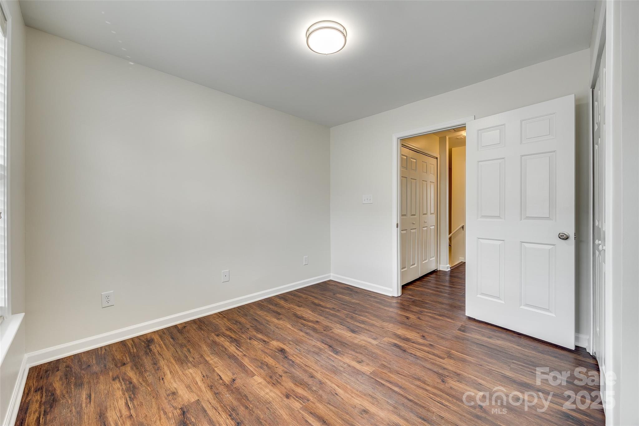 2035 Lennox Square Road Charlotte, NC 28210 - Photo 23 of 29 a view of an empty room with wooden floor and a window
