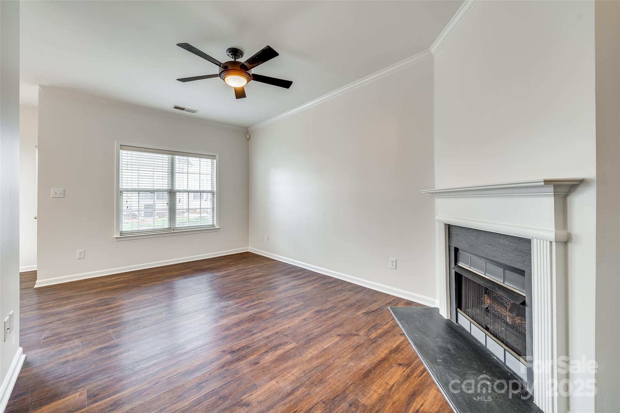 2035 Lennox Square Road Charlotte, NC 28210 - Photo 5 of 29 an empty room with ceiling fan and windows