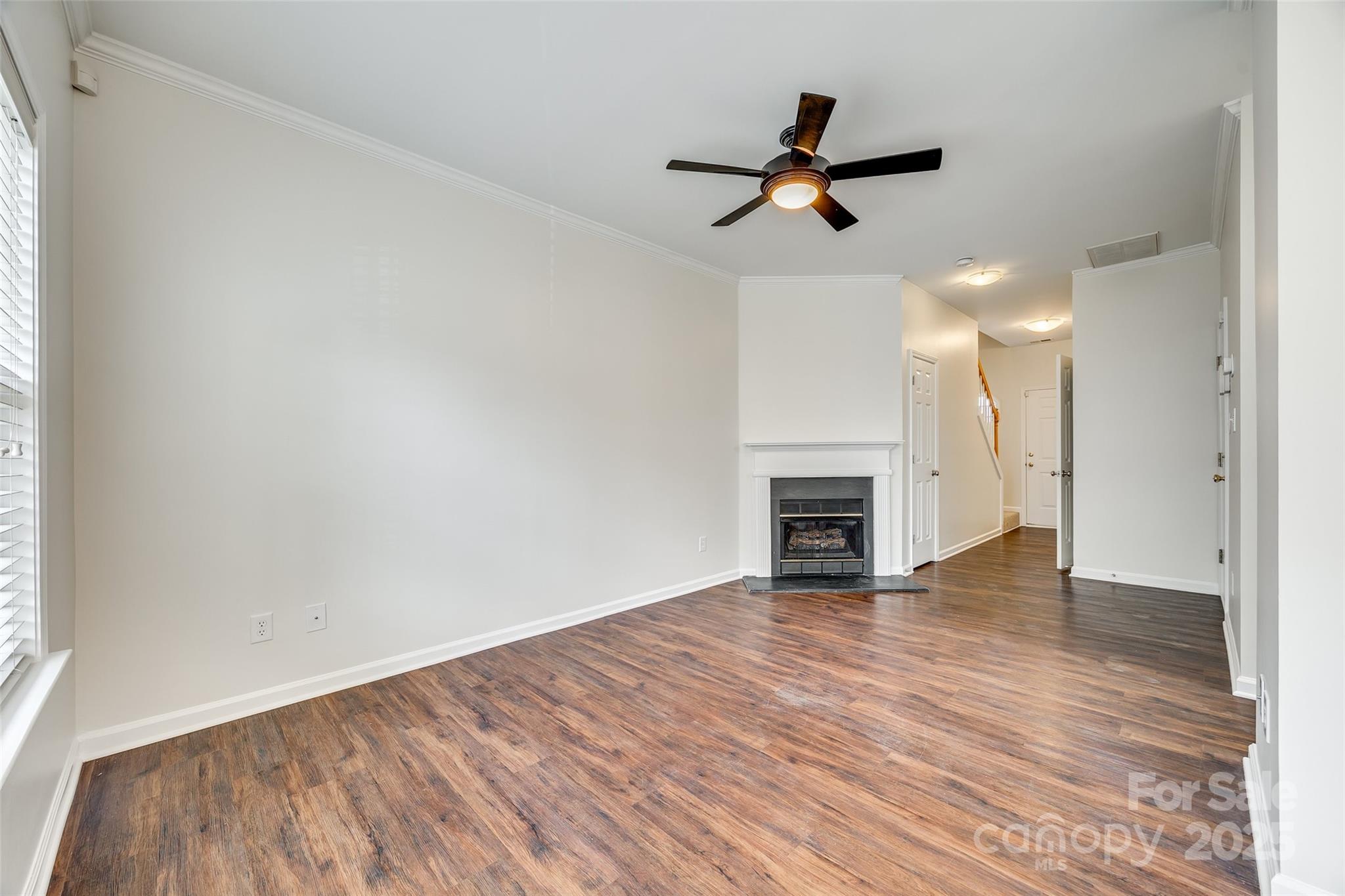 2035 Lennox Square Road Charlotte, NC 28210 - Photo 6 of 29 wooden floor in an empty room with a fireplace