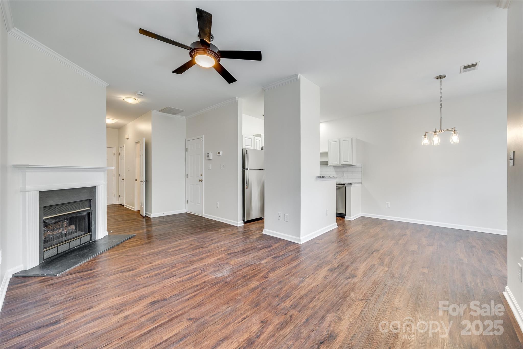 2035 Lennox Square Road Charlotte, NC 28210 - Photo 7 of 29 a view of empty room with wooden floor and fireplace