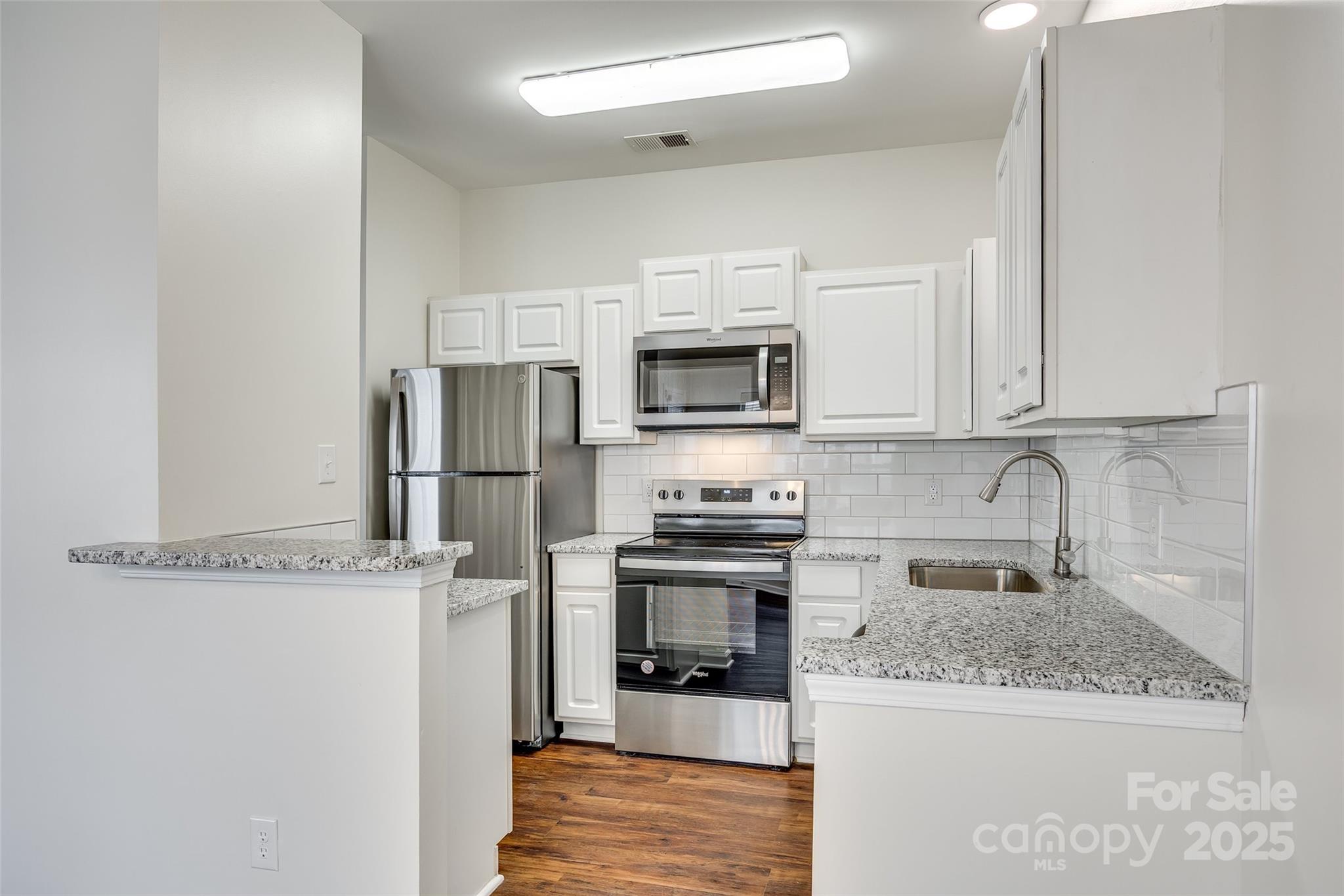 2035 Lennox Square Road Charlotte, NC 28210 - Photo 10 of 29 a kitchen with stainless steel appliances granite countertop a refrigerator a stove top oven a sink and dishwasher