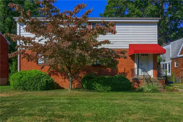 a view of a house with a yard and sitting area