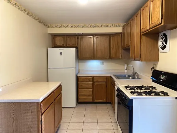 a kitchen with a refrigerator and a stove