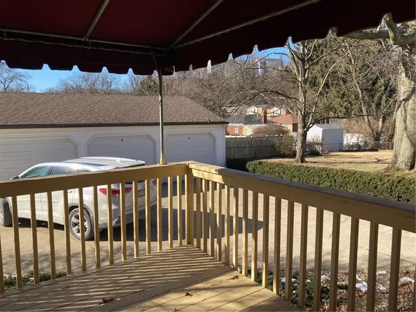 a view of a balcony with wooden fence