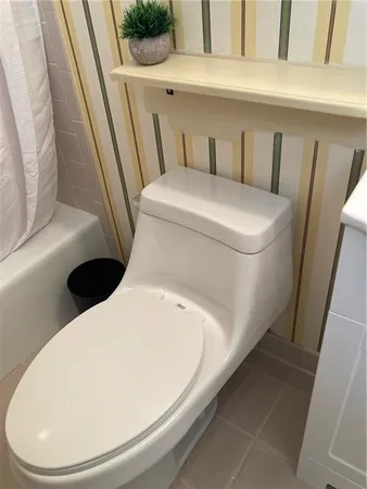 a white toilet sitting next to a white sink