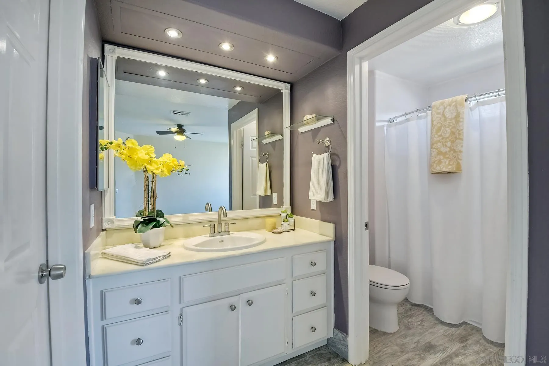13921 Midland Road Poway, CA 92064 - Photo 11 of 25 a bathroom with a granite countertop sink a toilet and a mirror