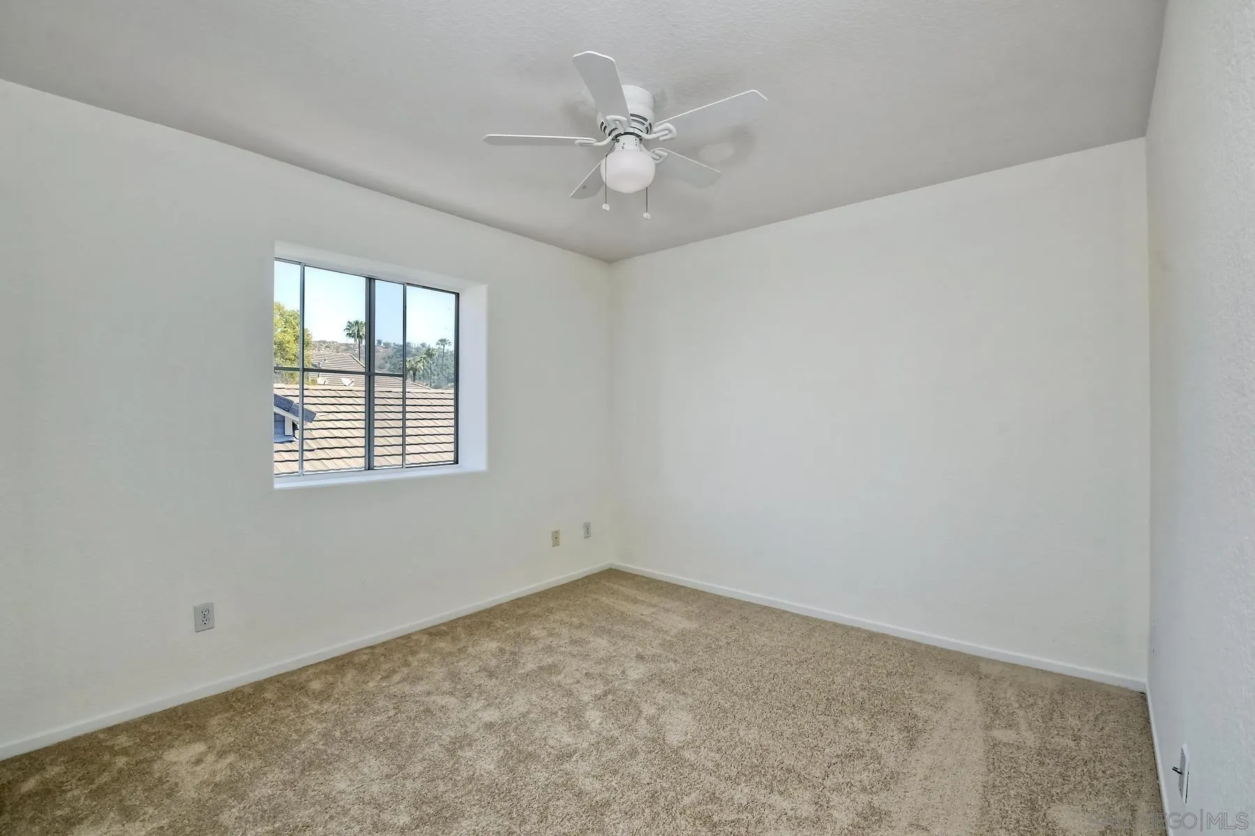 13921 Midland Road Poway, CA 92064 - Photo 15 of 25 an empty room with windows and ceiling fan