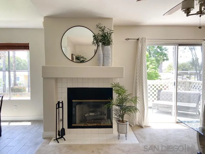 13921 Midland Road Poway, CA 92064 - Photo 4 of 25 a living room with a fireplace and a floor to ceiling window