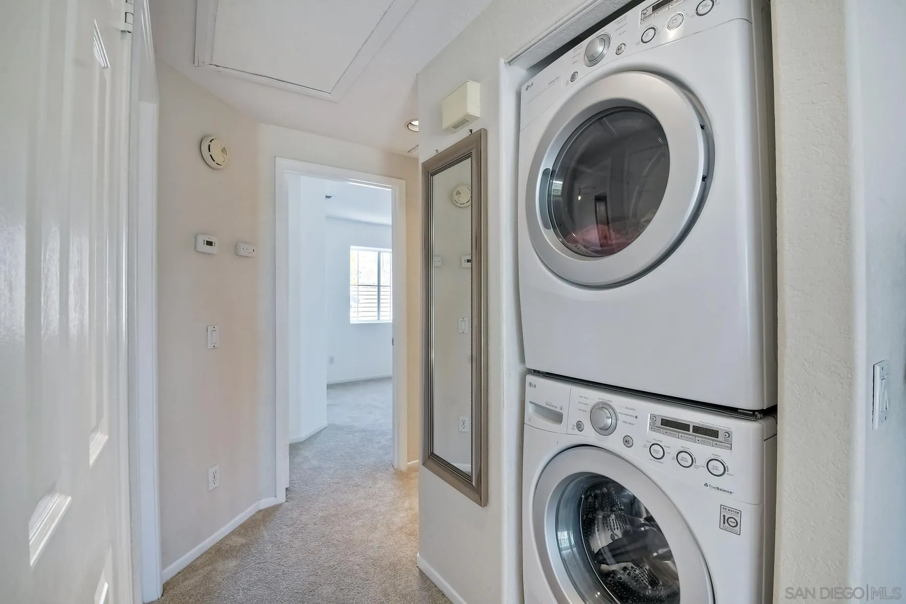 13921 Midland Road Poway, CA 92064 - Photo 7 of 25 a view of a hallway with washer and dryer