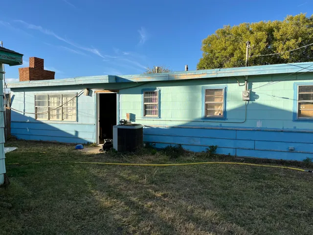 a view of backyard with wooden fence