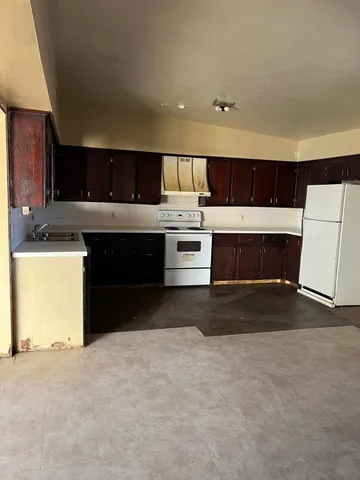 a kitchen with stainless steel appliances a stove a sink and a microwave