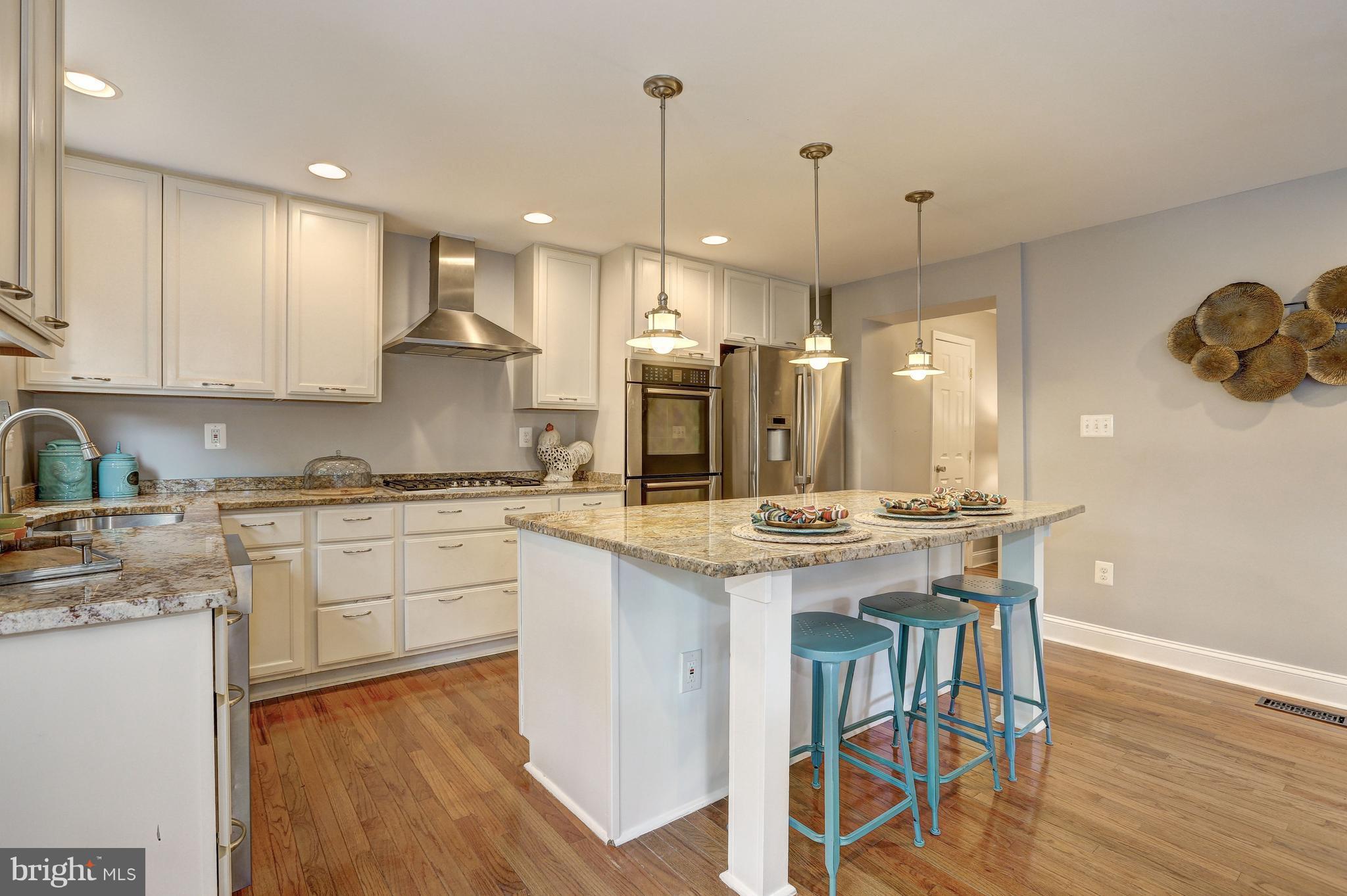 White kitchen w/ storage & counter seating