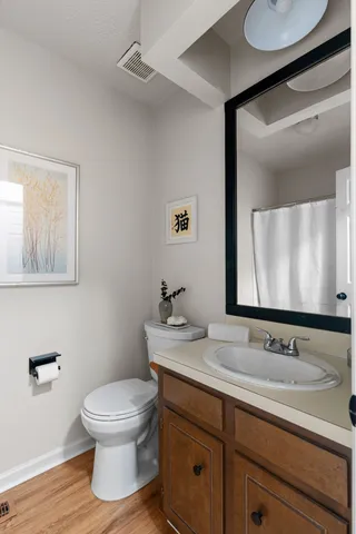 a bathroom with a sink a toilet and mirror