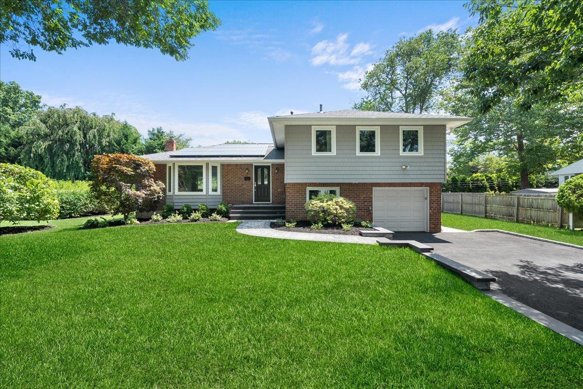 42 Earl Road Melville, NY 11747 - Photo 1 of 1 a front view of house with yard and green space