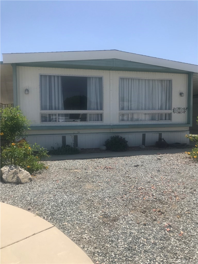 44717 Woodrow Way Hemet, CA 92544 - Photo 1 of 15 a view of backyard with wooden fence and a porch