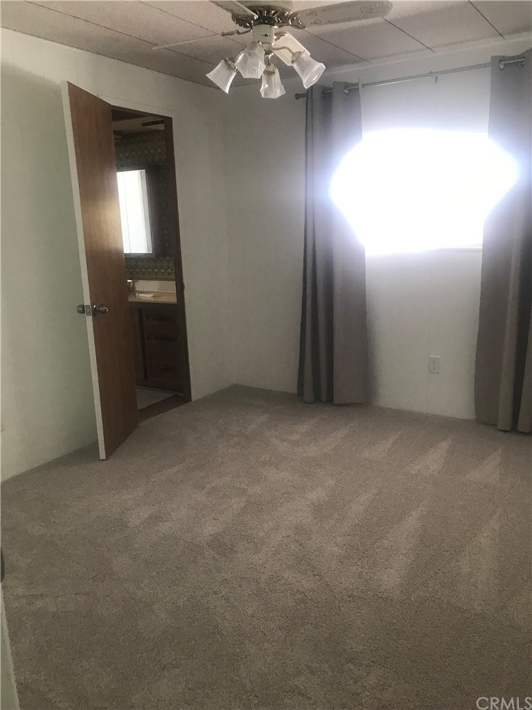 44717 Woodrow Way Hemet, CA 92544 - Photo 4 of 15 a view of an empty room with a chandelier fan