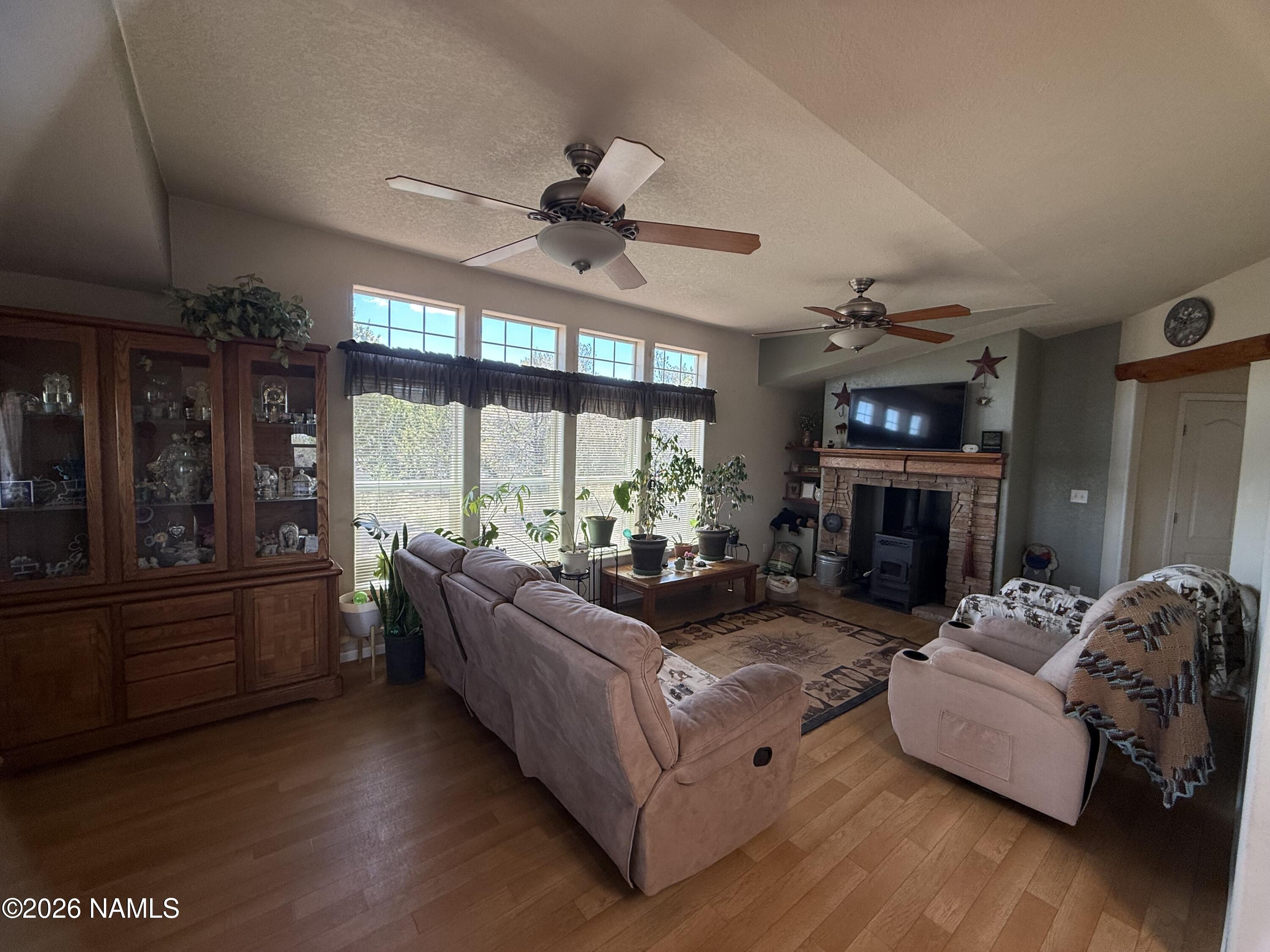 1431 East Cedar Road Williams, AZ 86046 - Photo 21 of 51 a living room with fireplace furniture and a large window