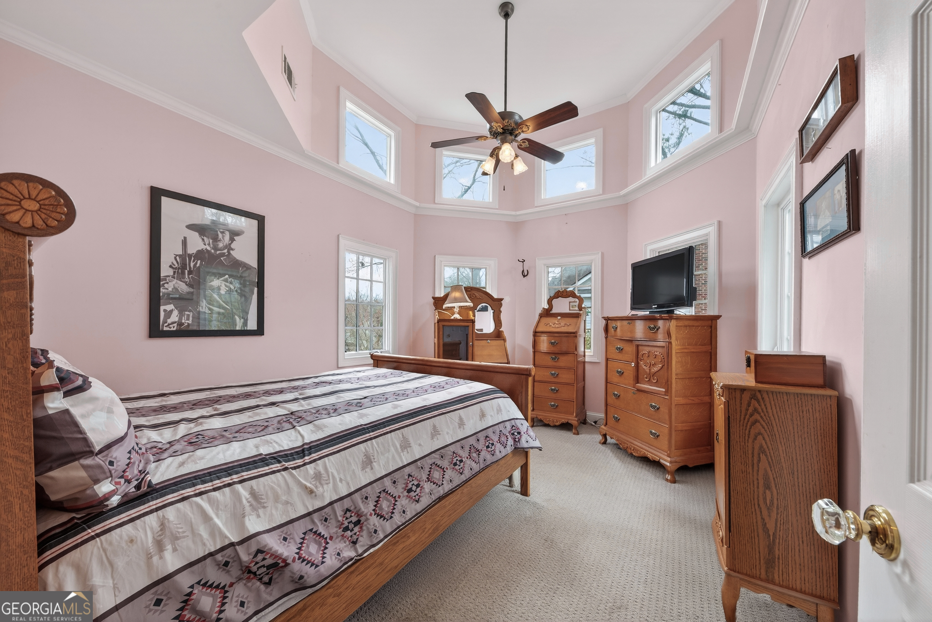 516 Hillside Road Madison, GA 30650 - Photo 21 of 27 a bedroom with a bed dresser and flat tv screen
