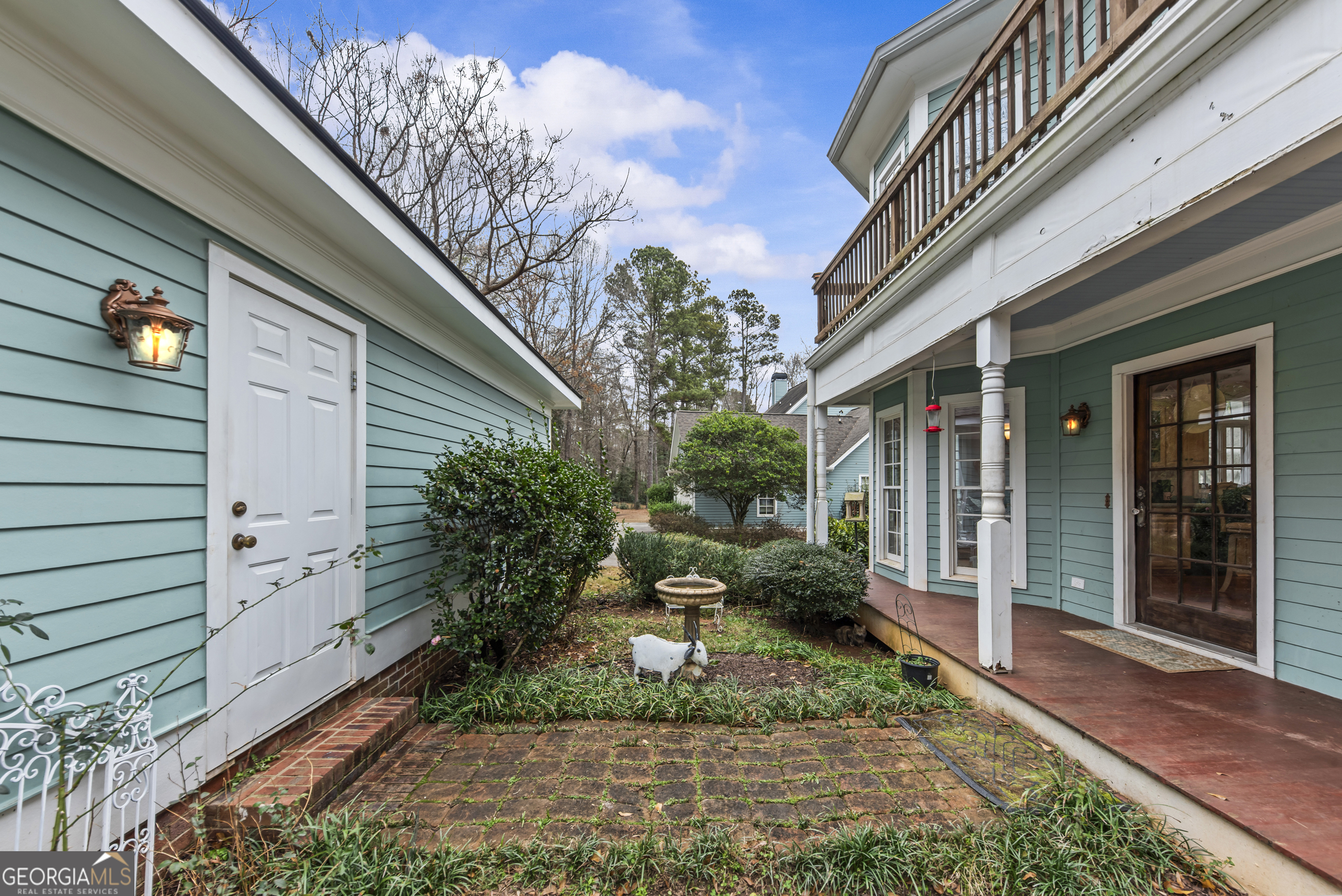 516 Hillside Road Madison, GA 30650 - Photo 24 of 27 a view of a house with brick walls and a yard