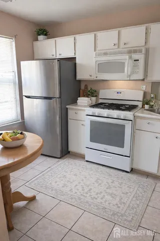 a kitchen with a stove top oven and refrigerator