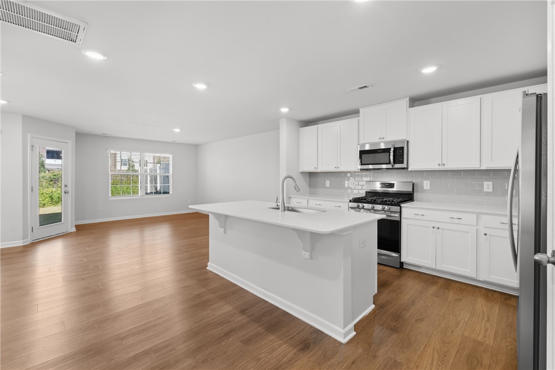 520 Brasstown Court Pendleton, SC 29670 - Photo 29 of 29 This kitchen and living area feature an open floor plan and abundant natural light.