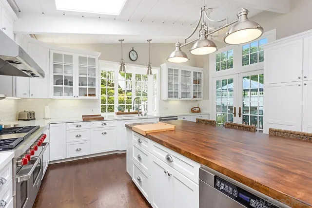 a kitchen that has a lot of cabinets in it