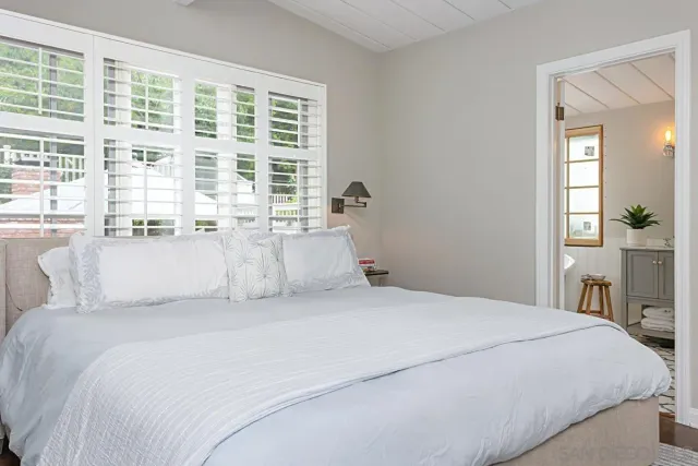 a bedroom with a large bed and a large window