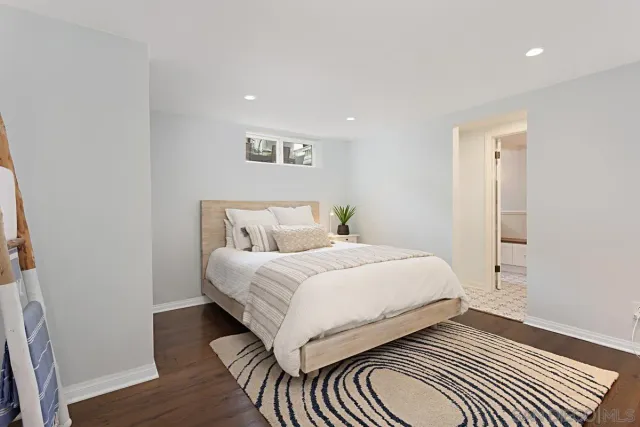 a bedroom with a bed and a night stand