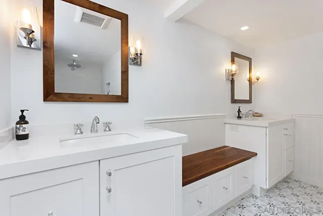 a bathroom with a sink vanity and mirror