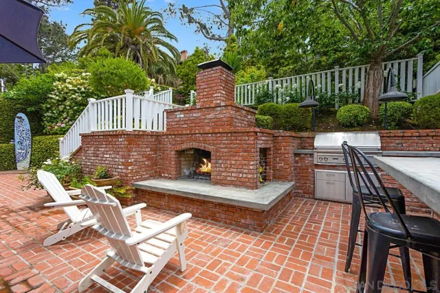 a front view of a house with garden and patio