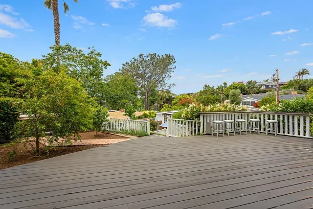 a view of a balcony with two chairs and a table
