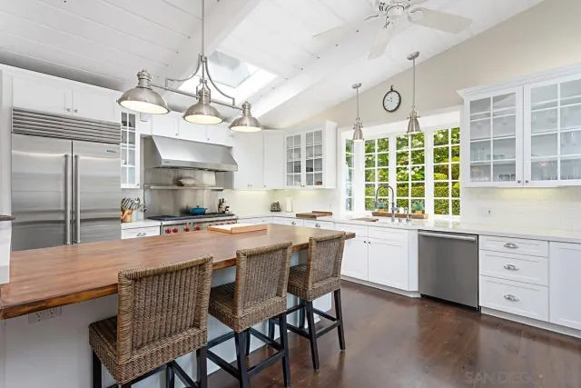 a large kitchen with a table and chairs in it