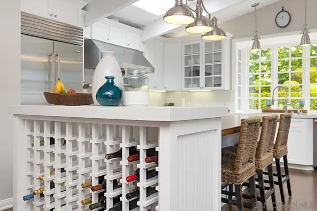 a kitchen with stainless steel appliances kitchen island granite countertop a table and chairs in it