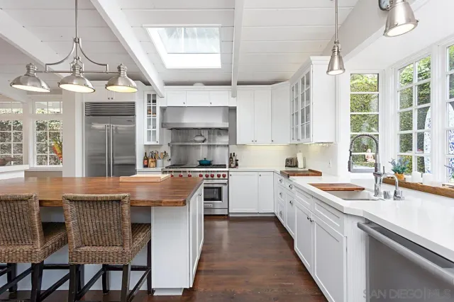 a kitchen with a stove a sink and a refrigerator