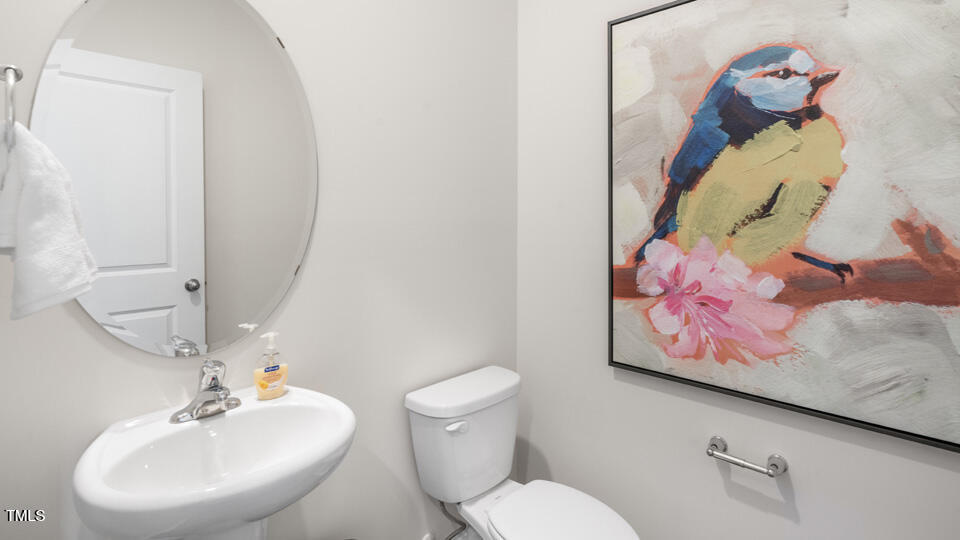 109 Pantaneiro Way Wake Forest, NC 27587 - Photo 13 of 32 a bathroom with a toilet sink and mirror