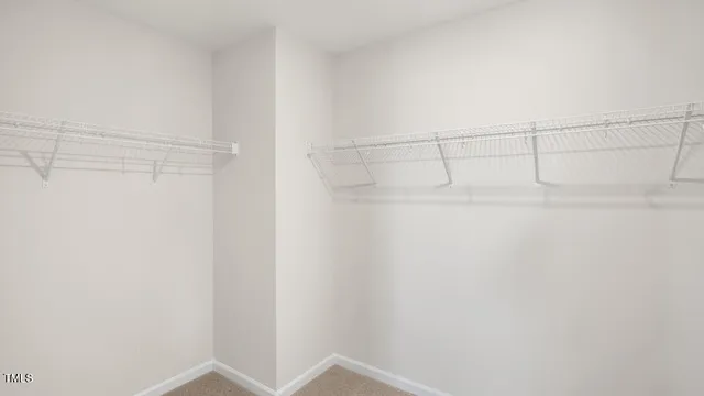 a bedroom with a bed and painting on the wall