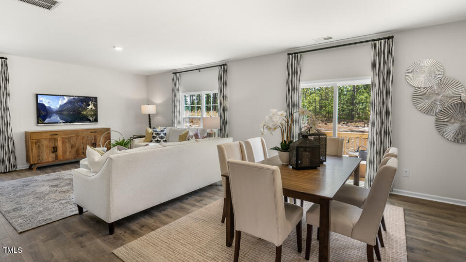 109 Pantaneiro Way Wake Forest, NC 27587 - Photo 8 of 32 a living room with furniture a flat screen tv and a large window